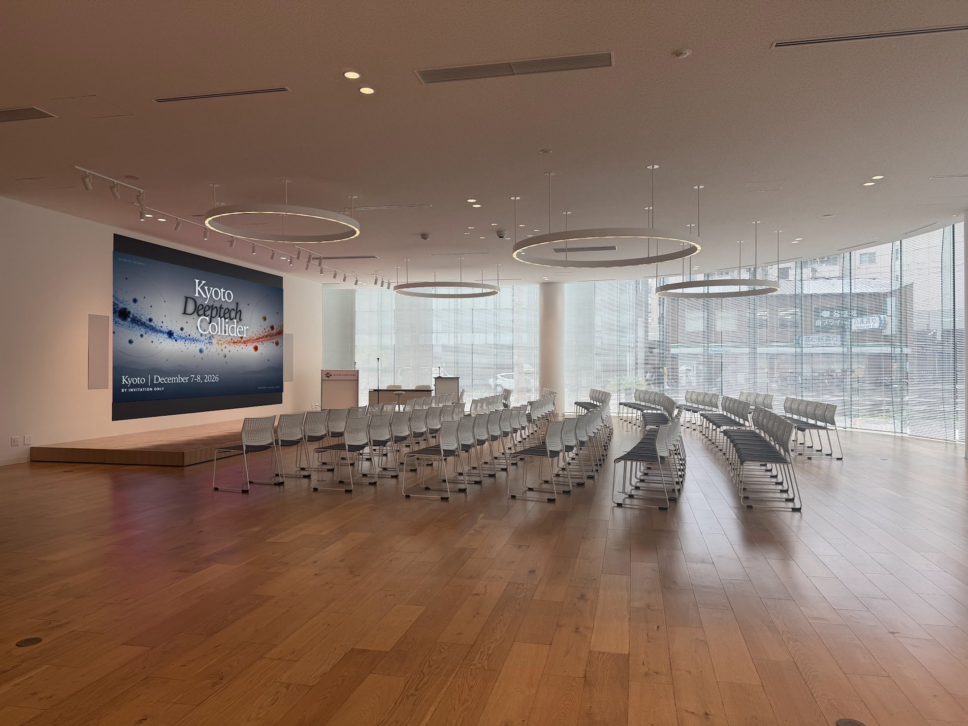KYOTO CENTCROSS 1F event hall with a large screen and rows of chairs